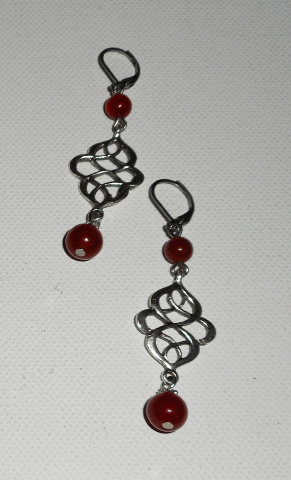 Celtic knot earrings with orange carnelian stones on silver sleepers