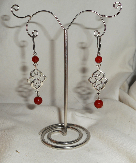 Celtic knot earrings with orange carnelian stones on silver sleepers