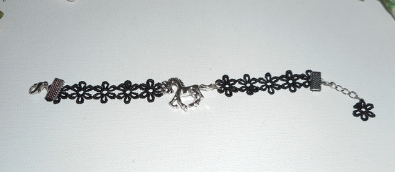 Original bracelet with silver metal horse on black lace