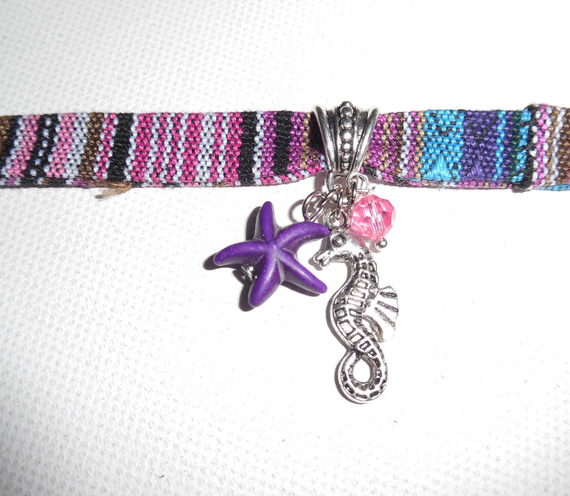 Colorful fabric bracelet with seahorse and purple starfish tassels