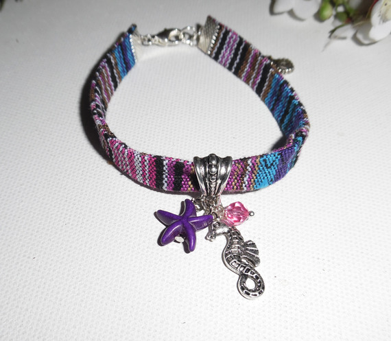 Colorful fabric bracelet with seahorse and purple starfish tassels