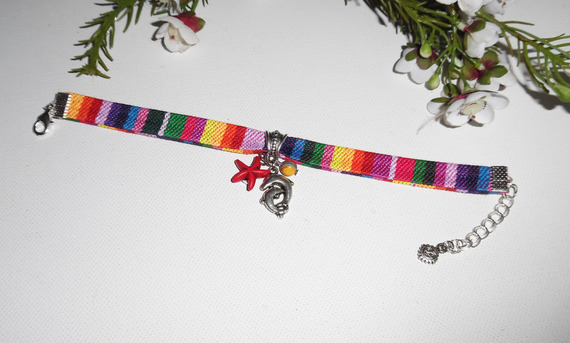 Colorful fabric bracelet with dolphin and red starfish tassels