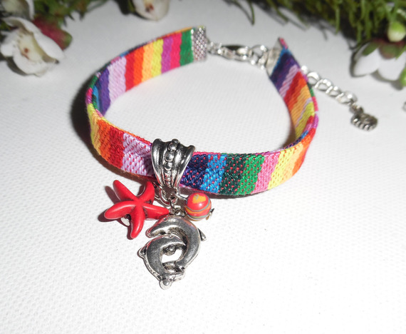 Colorful fabric bracelet with dolphin and red starfish tassels