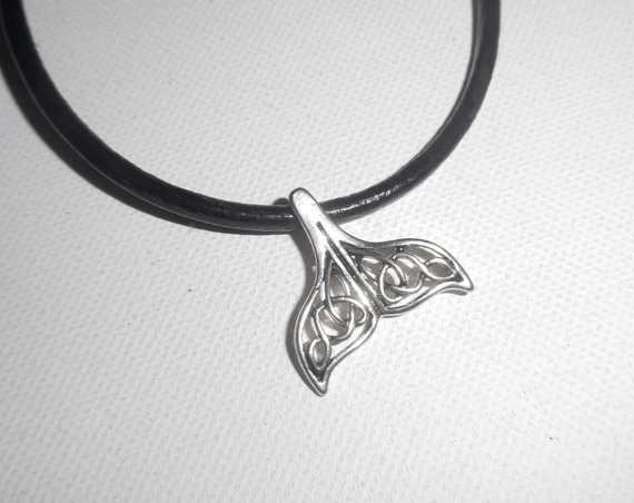 Pendant openwork dolphin tail lucky metal on black leather