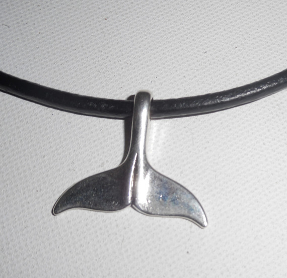 Silver dolphin tail pendant on black leather