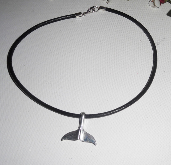 Silver dolphin tail pendant on black leather