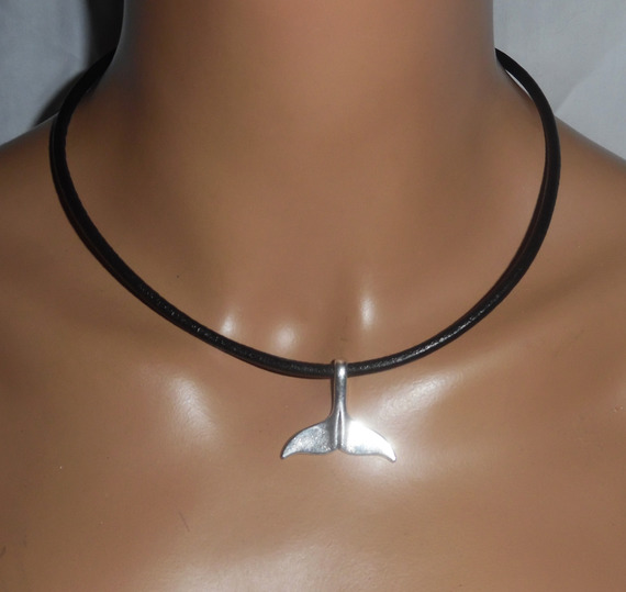 Silver dolphin tail pendant on black leather