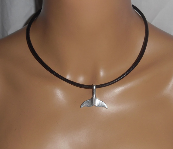 Silver dolphin tail pendant on black leather