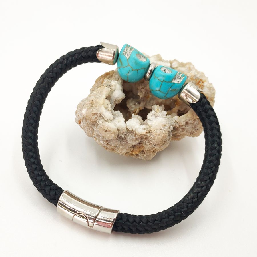 Black rope bracelet with double skull in blue stones