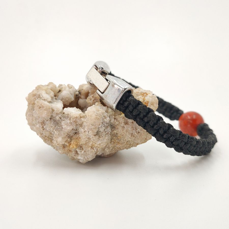 Woven rope bracelet with orange gorgon bead