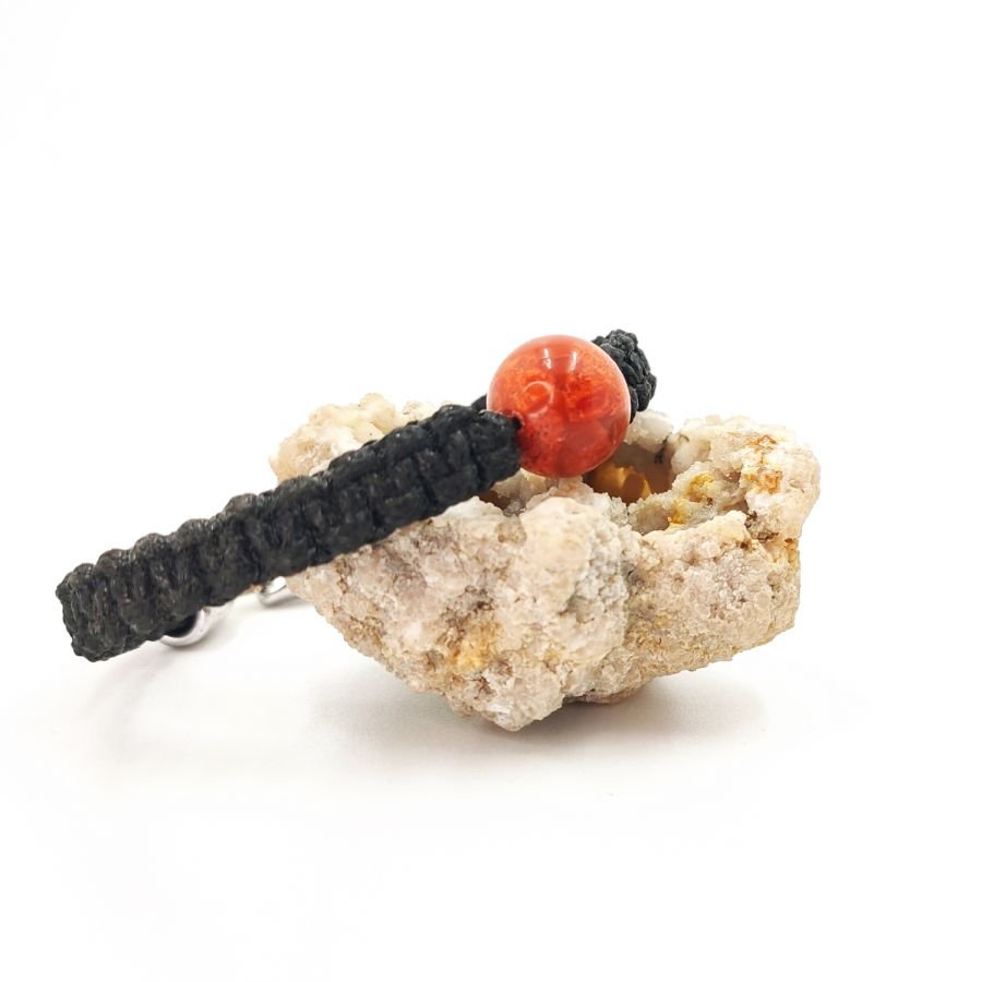 Woven rope bracelet with orange gorgon bead