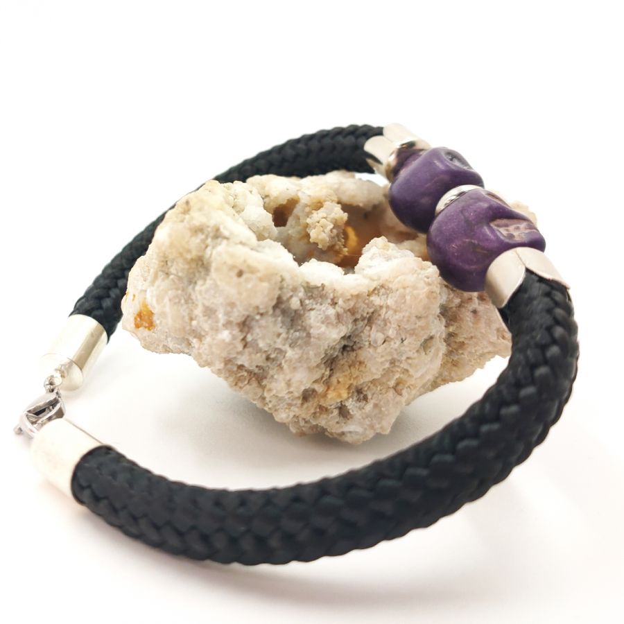 Double skull and crossbones bracelet with purple stones on black rope