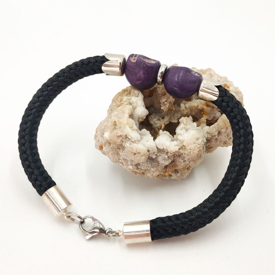 Double skull and crossbones bracelet with purple stones on black rope