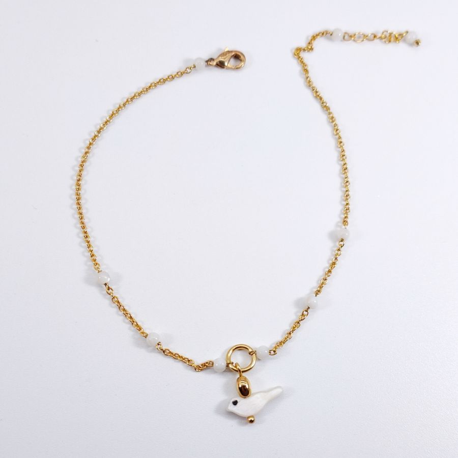 Anklet with mother-of-pearl beads and bird on gold plated stainless steel chain