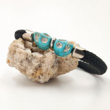 Black rope bracelet with double skull in blue stones